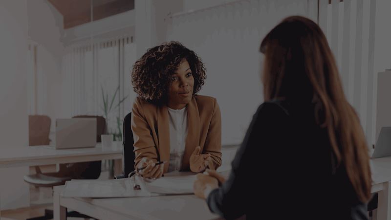 Picture of two business professionals having a discussion in an office setting